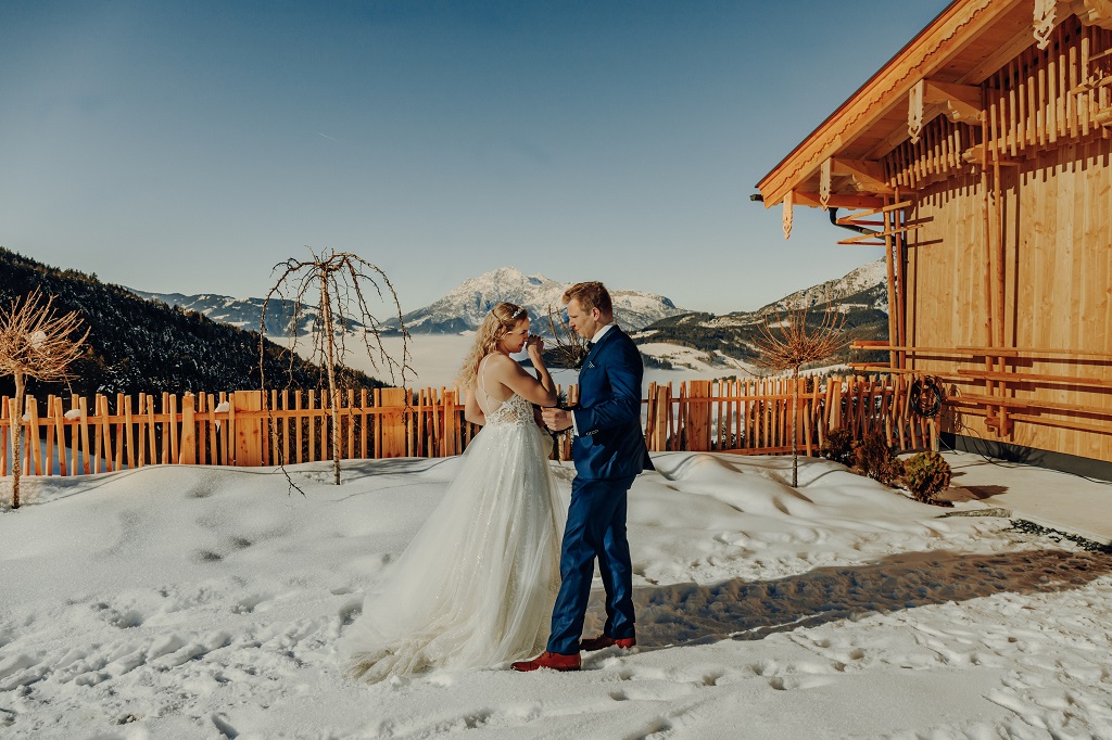 Emotional first look of the bride and groom at their winter wedding in the mountains