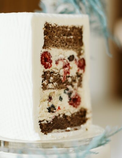 Angeschnittene Hochzeitstorte mit Beerenfüllung bei einer Winterhochzeit in den Bergen