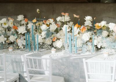 Dekorierter Dinnertisch mit weißen Stühlen auf einer Winterhochzeit in den Bergen Allgäus
