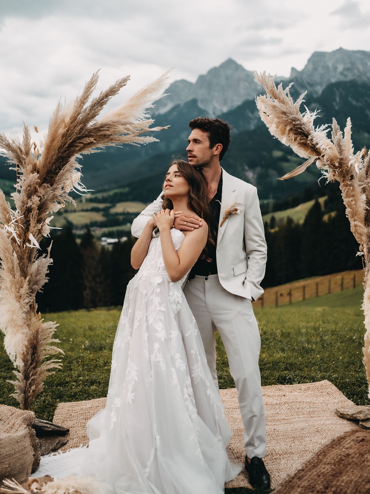 Bridal couple in front of the wedding arch at their mountain wedding in the Hochkönig region