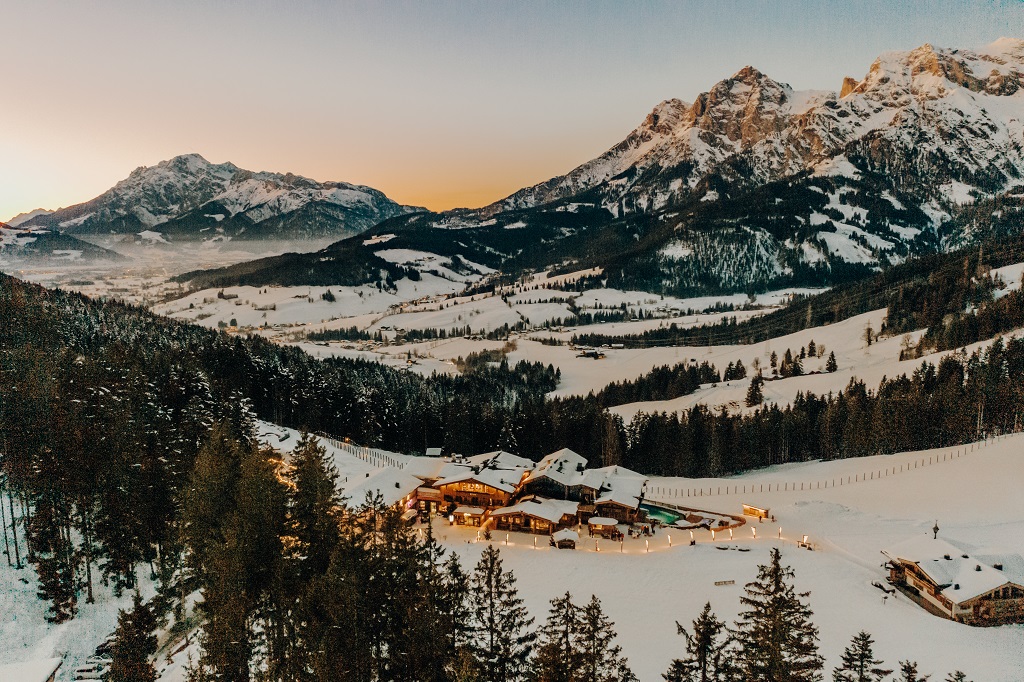 The Alpine Cabin Surrounded by Mountain Peaks in Winter