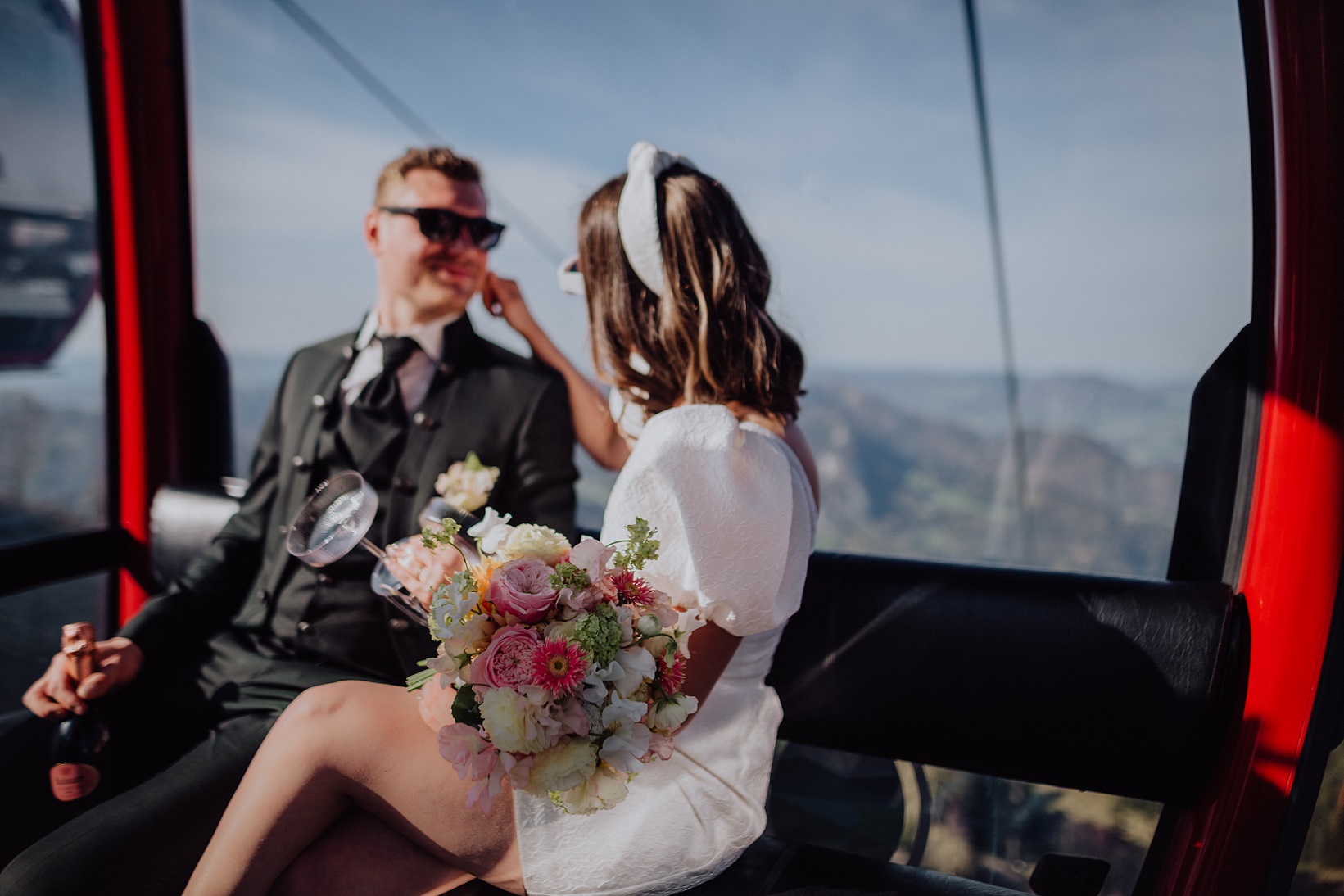 Bridal couple in the gondola as a shuttle at their wedding on the mountain